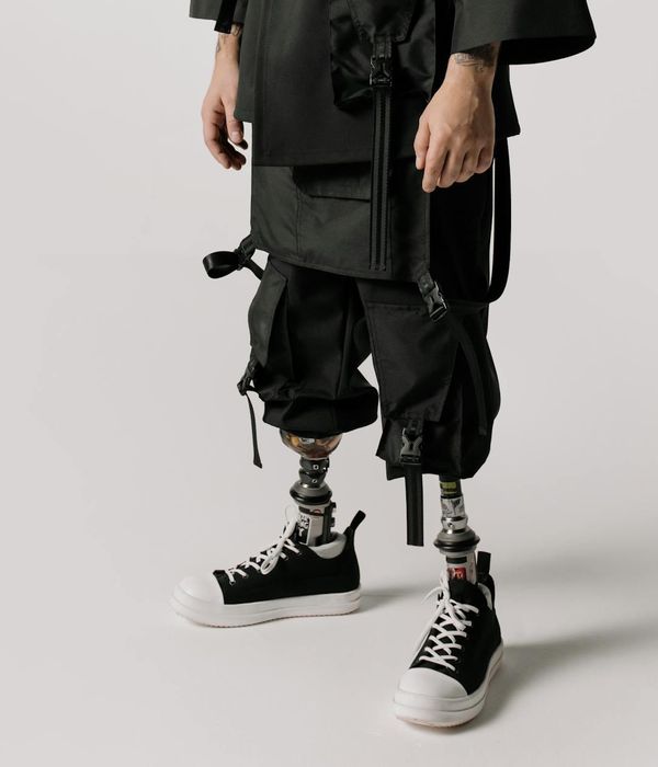 Person practicing gentle movements in a dark futuristic studio